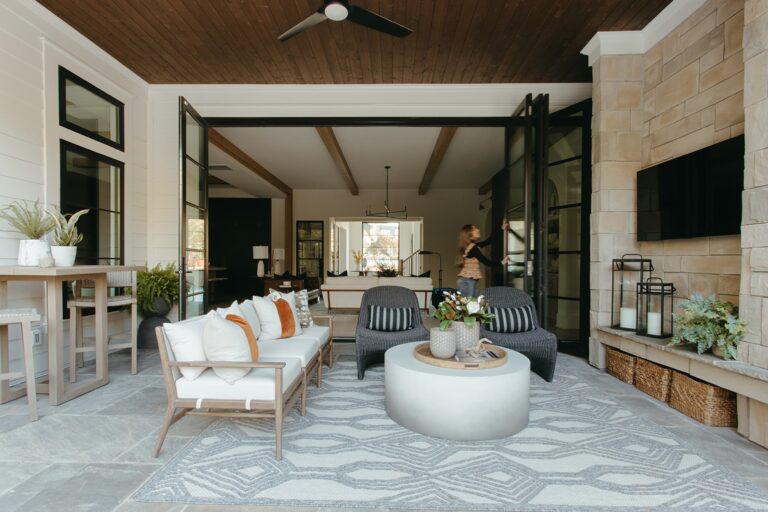 Covered outdoor living room with a fireplace and TV