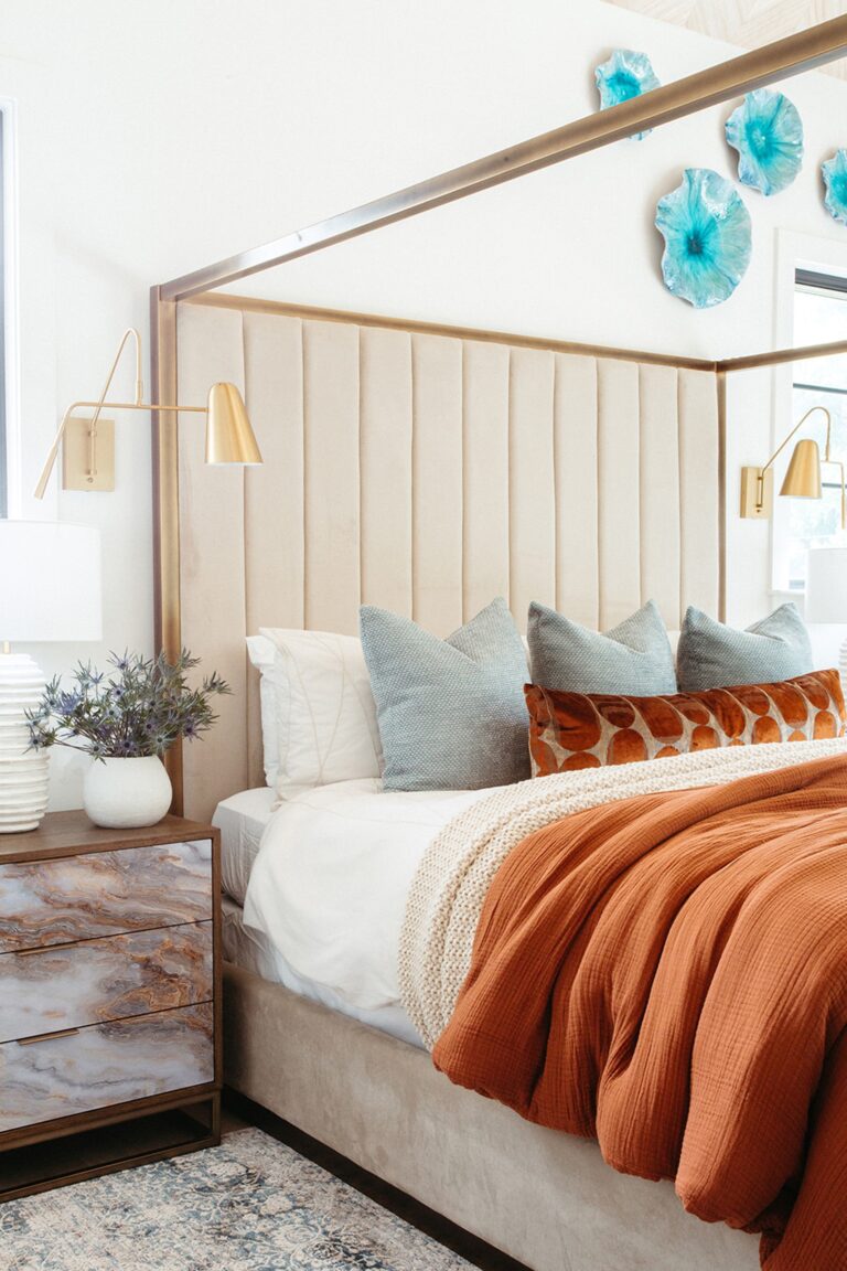 Primary bedroom with an upholstered headboard in a Copper home