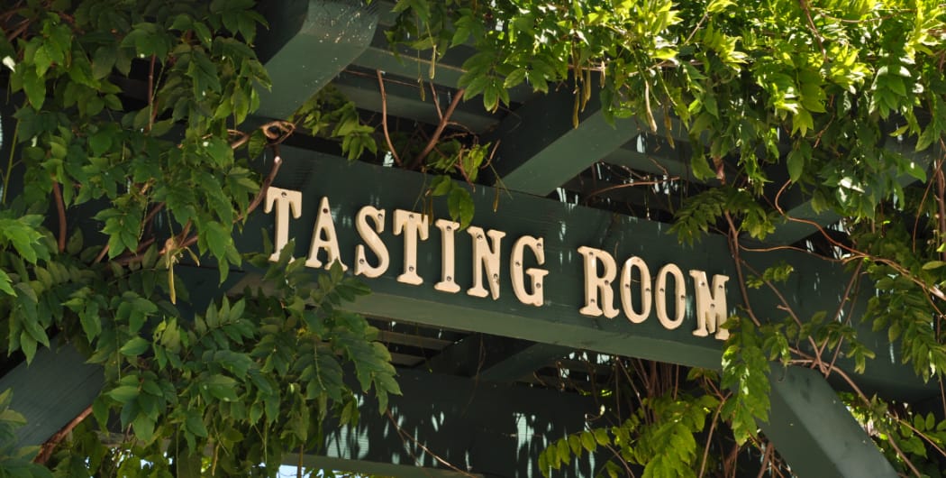 wine tasting room sign with greenery