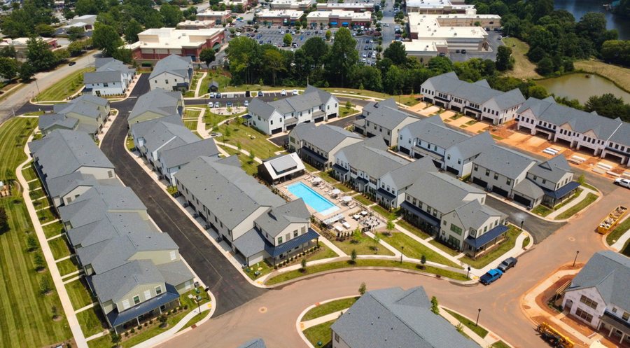 Aerial view of Jefferson Village build-to-rent townhomes with pool and amenity center