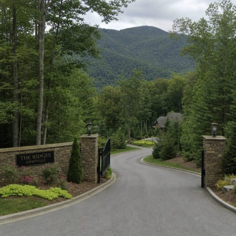 Gated community entrance on a winding road with Blue Ridge mountain views near Asheville, NC