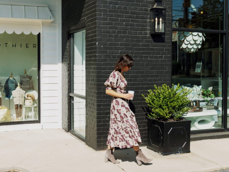 Woman walking past a boutique in downtown Asheville