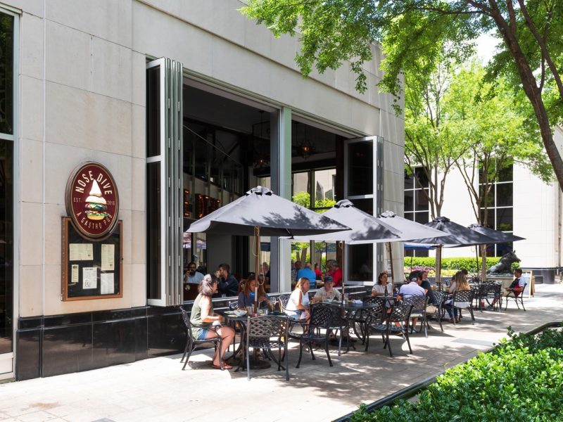 Greenville, SC, USA-23 June 2021: Nose Dive Pub, showing diners at sidewalk tables.